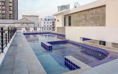 a swimming pool on the roof of a building at Citismart Luxury Apartments in Pattaya Central