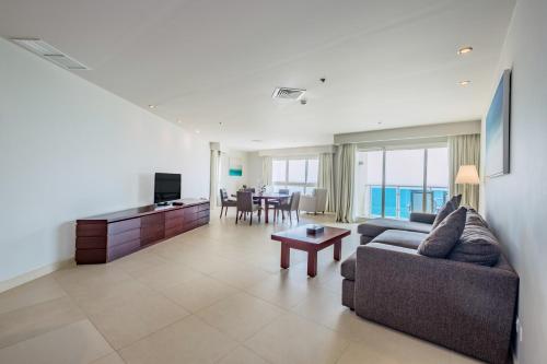 a living room with a couch and a table at Radisson Blu Resort, Fujairah in Dibba