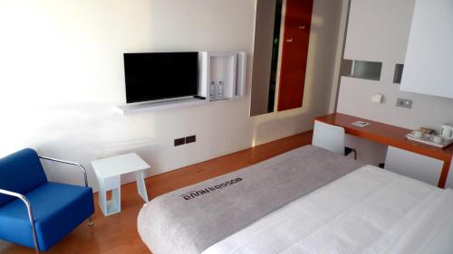 a hospital room with a bed and a tv at Bossa Nova Beirut Hotel in Beirut