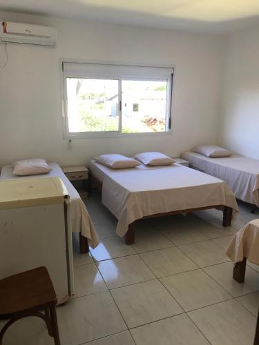 Postel nebo postele na pokoji v ubytování Apart Hotel Alegrete