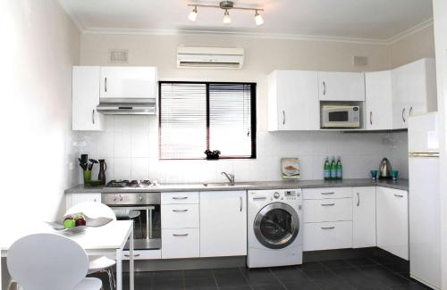 A kitchen or kitchenette at Stylish North Adelaide Apartments