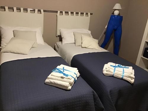 2 łóżka w pokoju z ręcznikami w obiekcie Original b&b w mieście Porto Torres