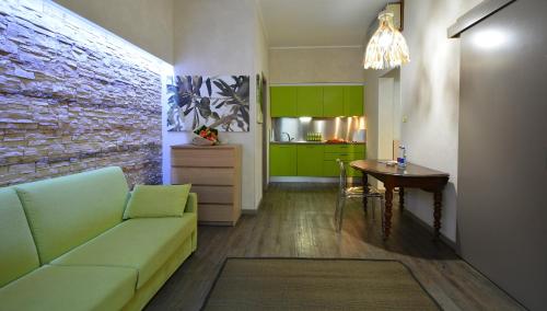 a living room with a couch and a table and a kitchen at Residence Star in Turin