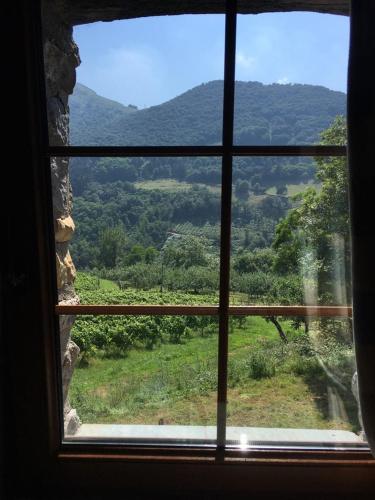 a window with a view of a mountain view at Agroturismo Erlete Goikoa -ESTAMOS EN EL CAMINO DE SANTIAGO -WE ARE ON THE CAMINO DE SANTIAGO in Deba