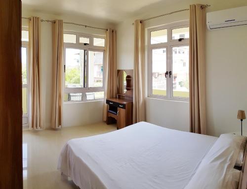 Ένα ή περισσότερα κρεβάτια σε δωμάτιο στο Colosseo Apartments