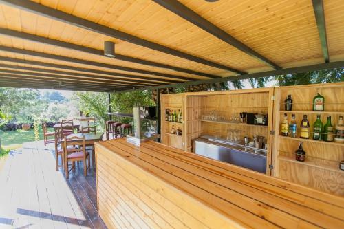 a wooden bar on a deck with a table and chairs at Agroturismo Can Pere Sord in Sant Joan de Labritja