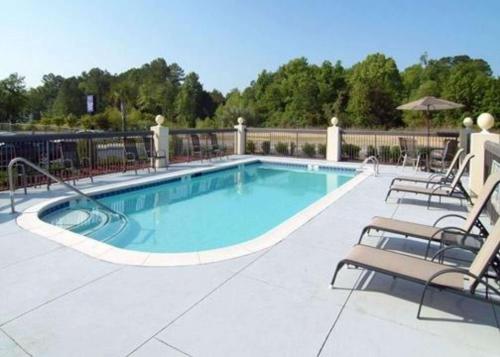 a large swimming pool with chairs at Sleep Inn Walterboro I-95 in Walterboro