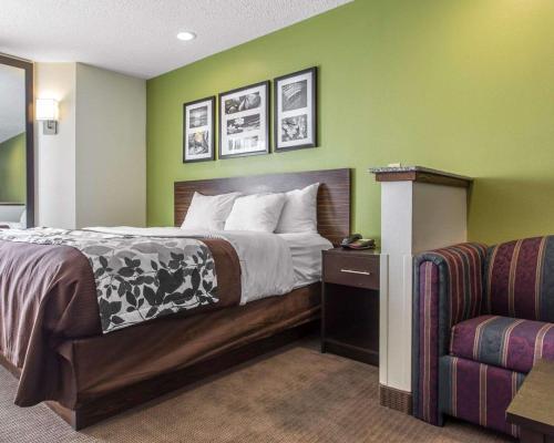 a hotel room with a bed and a couch at Sleep Inn Columbia in Columbia