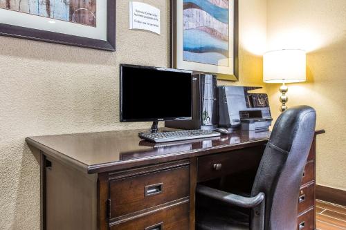 a desk with a computer and a chair in a hotel room at Quality Inn & Suites Orangeburg in Orangeburg
