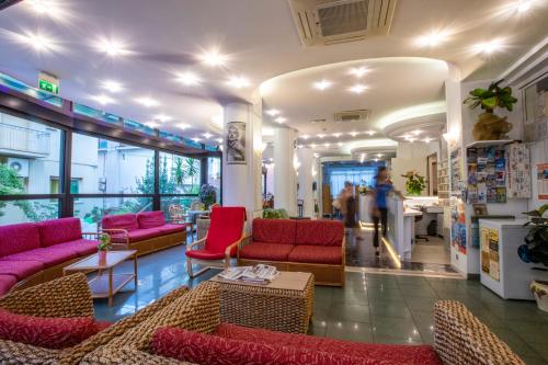 a lobby with couches and chairs in a store at Hotel Holland in Rimini