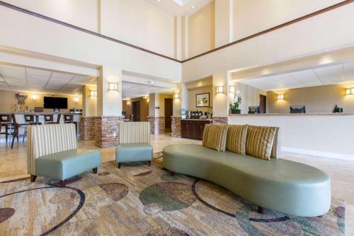a living room with a couch and two chairs at The Oaks Hotel & Suites in Paso Robles