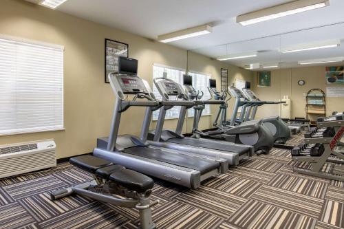 a gym with several tread machines in a room at Suburban Studios Birmingham Homewood I-65 in Birmingham