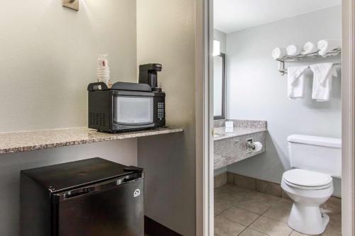 a small bathroom with a toilet and a microwave at Quality Inn Downtown Historic District in Mobile