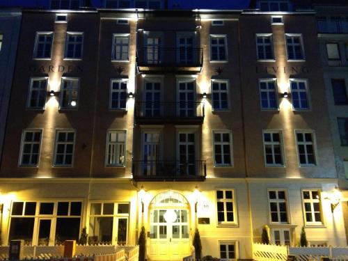 a large building at night with lights on it at Garden Living - Boutique Hotel in Berlin