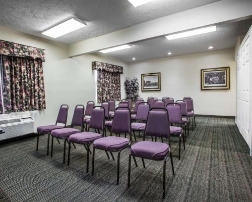 a conference room with purple chairs and curtains at Quality Inn Florence East in Florence
