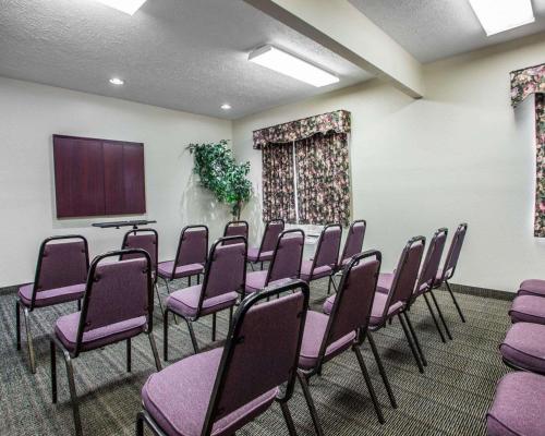 a conference room with purple chairs and a screen at Quality Inn Florence East in Florence