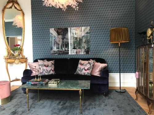 a living room with a couch and a table at Annas Hotell in Kristianstad