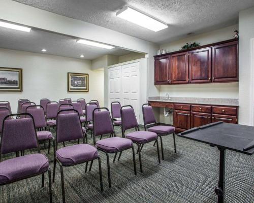 a conference room with purple chairs and a table at Quality Inn Florence East in Florence