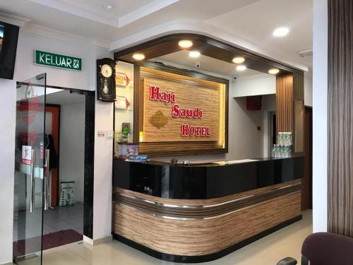 a restaurant with a light sushi bureau sign on a counter at Haji Saudi Hotel in Cameron Highlands