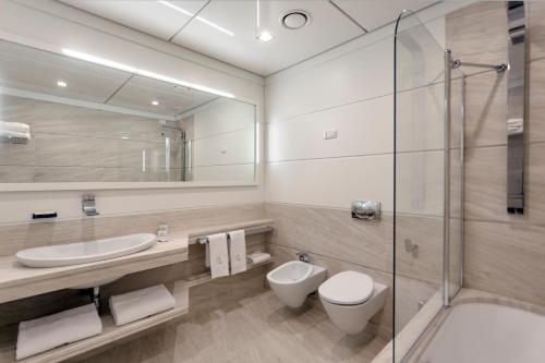 a bathroom with a toilet and a sink and a shower at Yacht Club Marina Di Loano in Loano