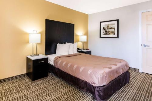 a hotel room with a bed and two lamps at Quality Inn Trussville I-59 exit 141 in Trussville