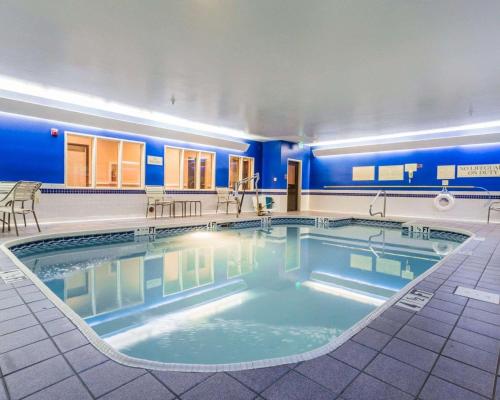 a large swimming pool in a building with blue walls at Quality Inn & Suites Birmingham - Highway 280 in Birmingham
