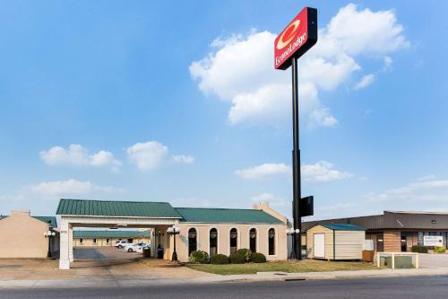 a coke sign in front of a gas station at Econo Lodge Jonesboro in Jonesboro
