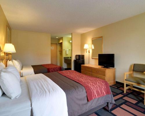 a hotel room with two beds and a television at Quality Inn & Suites Malvern in Malvern