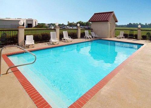 a large blue swimming pool with lounge chairs at Quality Inn & Suites Pine Bluff AR in Pine Bluff