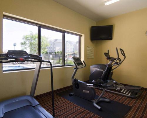 a fitness room with two exercise bikes and a window at Affordable Suites of America Rogers - Bentonville in Rogers