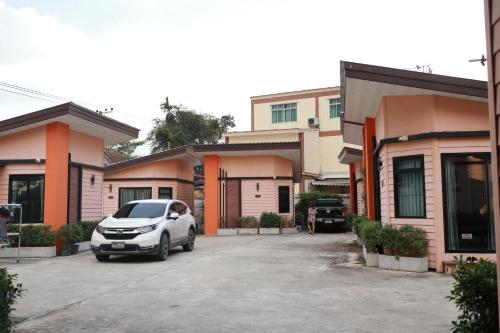 a car parked in a parking lot in front of buildings at Angie Resort at Sapan Mai in Bangkok