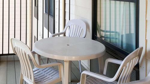 a white table and chairs on a balcony at Affordable Suites of America Rogers - Bentonville in Rogers