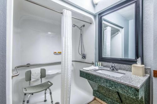 a bathroom with a sink and a mirror at Quality Suites Maumelle - Little Rock NW in Maumelle