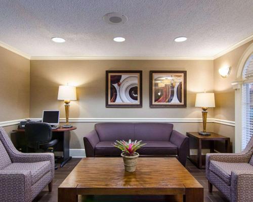 a waiting room with a couch and chairs and a table at Quality Inn & Suites Little Rock West in Little Rock