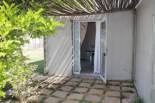 an entrance to a house with an open door at Berry Lane Guesthouse in Kroonstad