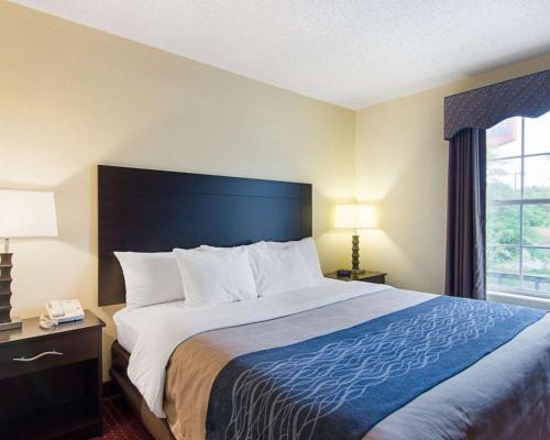 a hotel room with a large bed and a window at Quality Inn & Suites Little Rock West in Little Rock