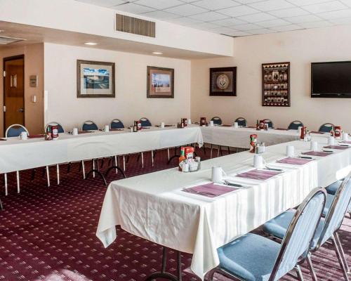 a conference room with tables and chairs and a flat screen tv at Navajo Nation Inn in Window Rock