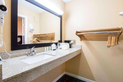 a bathroom with a sink and a mirror at Quality Inn Arkadelphia - University Area in Arkadelphia