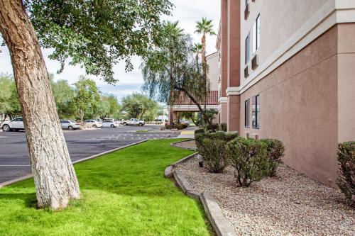 a building with a green lawn next to a street at Comfort Inn Chandler - Phoenix South I-10 in Chandler