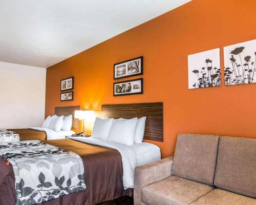 a hotel room with two beds and a couch at Sleep Inn & Suites Page at Lake Powell in Page