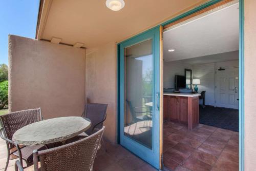 a bathroom with a walk in shower next to a bench at La Posada Lodge & Casitas, Ascend Hotel Collection in Tucson