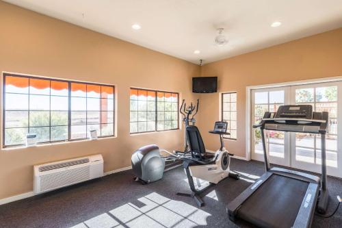 a gym with a treadmill and a room with windows at Quality Inn Casa Grande I-10 in Casa Grande