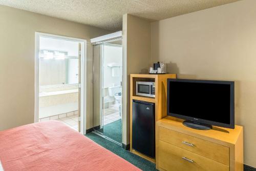 a bedroom with a television on a dresser with a bed at Quality Inn Casa Grande I-10 in Casa Grande