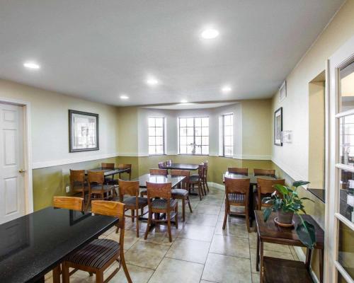 a dining room with tables and chairs and a large window at Quality Inn Holbrook in Holbrook
