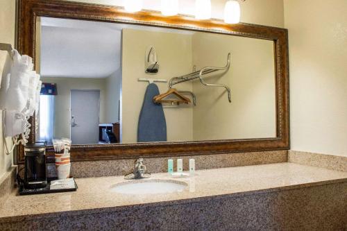 a bathroom with a sink and a large mirror at Quality Inn Benson I-10 Exit 304 in Benson