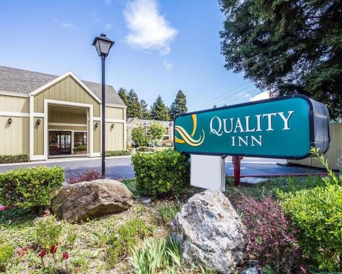 a sign for a quality inn in front of a house at Quality Inn Petaluma - Sonoma in Petaluma