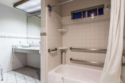 a bathroom with a tub and a sink at Quality Inn & Suites Silicon Valley in Santa Clara