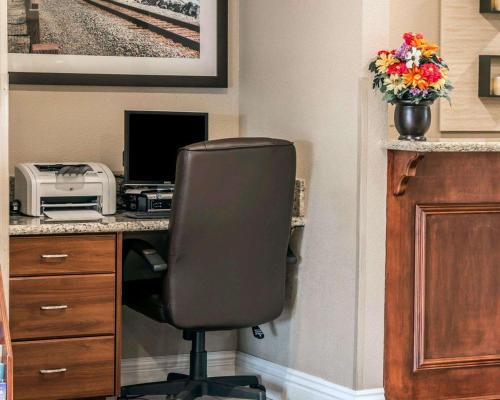 an office with a desk with a computer and a chair at Comfort Suites San Clemente Beach in San Clemente