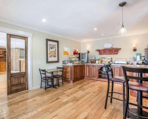 una cocina con mesas y sillas de madera en una habitación en Quality Inn Buellton - Solvang, en Buellton