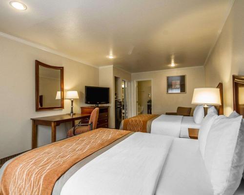 a hotel room with two beds and a television at Blu Pacific Hotel in Monterey